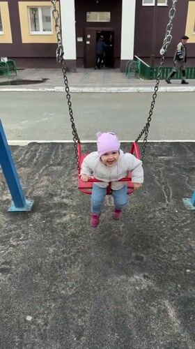 Toddler enjoys swing time at Tobolsk playground