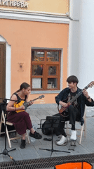 Street band performs live outside a pink building in Nizhny Novgorod