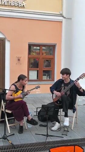 Street band performs live outside a pink building in Nizhny Novgorod
