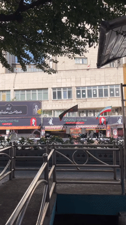 Street life and political banners mix in central Tehran
