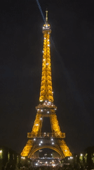 Eiffel Tower sparkles with golden lights in Paris evening