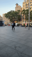 Skateboarders practice tricks in Barcelona plaza evening session