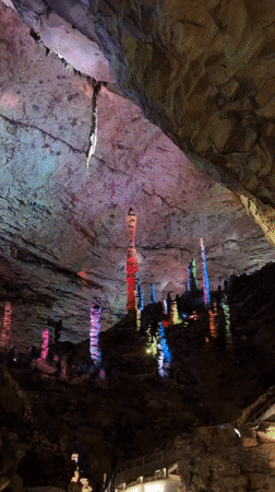 Tourist explores illuminated caves and cultural sites in Jundiping