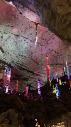 Tourist explores illuminated caves and cultural sites in Jundiping