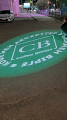 Coffee Boom ad projected on street pavement in Kazakhstan