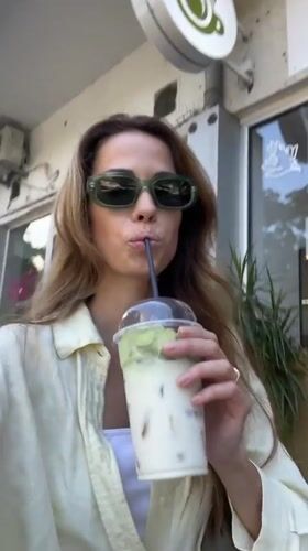 Woman enjoys matcha smoothie at Montenegro cafe