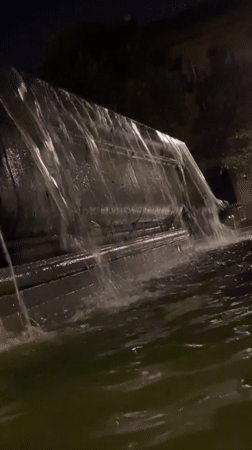 Nighttime hangout by a fountain with candles and low light