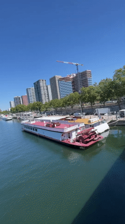 Tour boats moored along the Seine on a sunny Paris afternoon