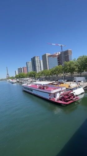 Tour boats moored along the Seine on a sunny Paris afternoon