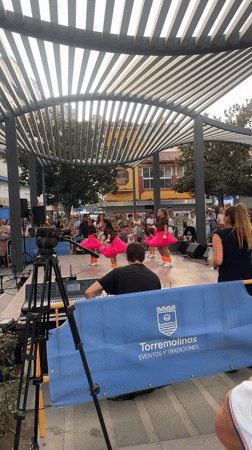 Dance group performs outdoors in matching pink tutus, Torremolinos