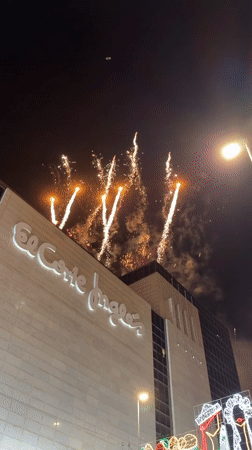 Fireworks light up the sky above El Corte Inglés