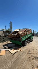 Dump truck unloads scrap wood in Varna dirt lot