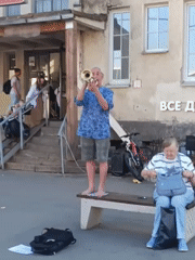 Street musician performs at Saint Petersburg station during afternoon market