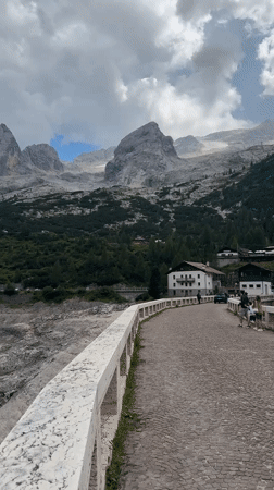Exploring a concrete arch dam in the Dolomites near Canazei