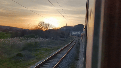 Train passenger films golden sunset view near Venchan, Bulgaria