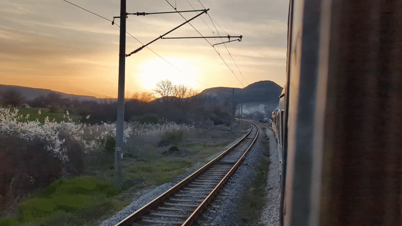Train passenger films golden sunset view near Venchan, Bulgaria