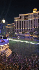Bellagio fountains glow against Las Vegas night sky