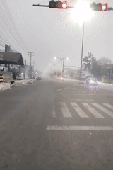Misty morning traffic along foggy roads in Kalimantan, Indonesia