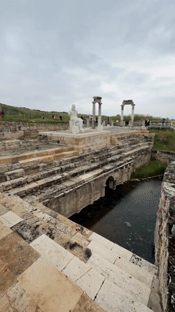 Tourist documents ancient Hierapolis ruins and statues in Pamukkale