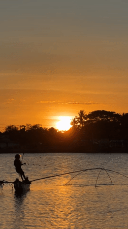 Sunset fishing scene captured in West Praya, Indonesia