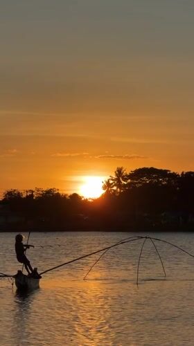 Sunset fishing scene captured in West Praya, Indonesia