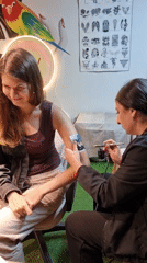 Woman gets airbrush tattoo in Kemer, Turkey
