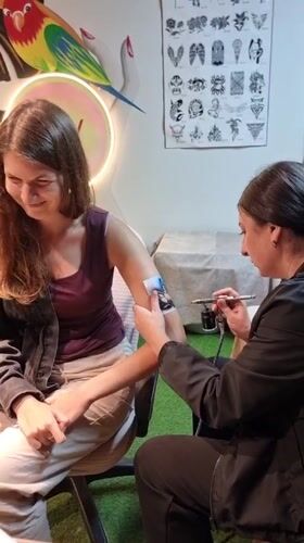 Woman gets airbrush tattoo in Kemer, Turkey