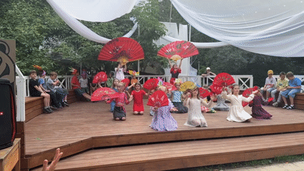 Children perform fan dance at outdoor Moscow cultural event