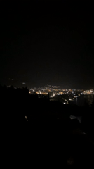 Nighttime city lights reflected in water observed in Montenegro