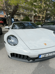 Man poses with white Porsche for selfies in Plovdiv