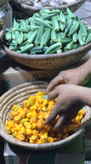 Evening market vendor sells produce from baskets in Abuja