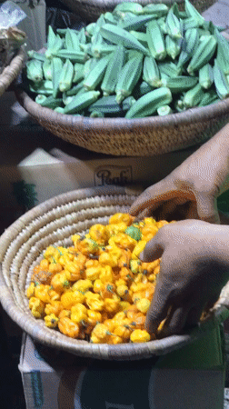 Evening market vendor sells produce from baskets in Abuja
