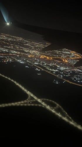 Nighttime aerial view captures illuminated Vsevolozhsk city from airplane