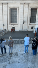 Tourists photograph Swiss Guards in Vatican City courtyard