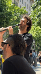 Street musician plays clarinet in Barcelona public square