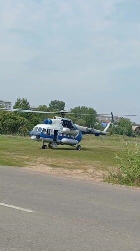 Helicopter lands on grassy roadside area