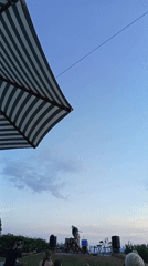 Hillside concert overlooks ocean at sunset, May 21