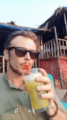 Man enjoys cold drink on Arambol beach