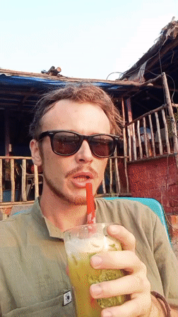 Man enjoys cold drink on Arambol beach
