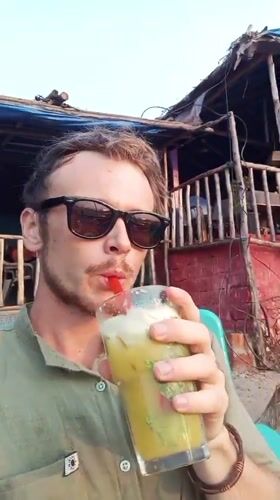 Man enjoys cold drink on Arambol beach