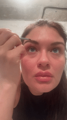 Woman applies eyebrow makeup on camera in Khimki