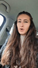 Woman singing in car during morning commute in Sofia