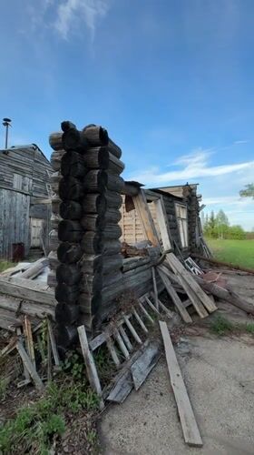 Abandoned log cabin documented in partial collapse, Russia