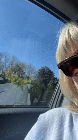 Woman travels by car through French countryside