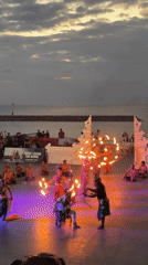 Kecak fire dancers perform at sunset on Kuta's beachfront stage