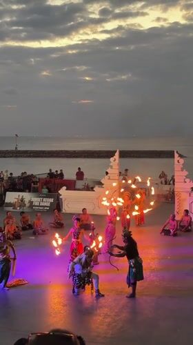 Kecak fire dancers perform at sunset on Kuta's beachfront stage