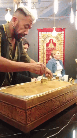 Man demonstrates traditional Turkish coffee preparation in Santiago