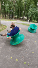 Kicked back in a green spinning chair at the park