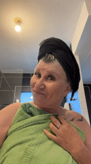 Woman dries hair in Chambœuf bathroom Monday evening