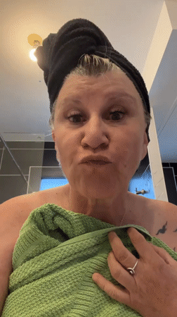Woman dries hair in Chambœuf bathroom Monday evening
